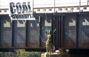 protester dressed as gecko blocks coal trains