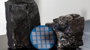 A wafer containing memristors fabricated with high-quality two-dimensional carbon processed from bituminous Blue Gem coal mined in southeastern Kentucky, two samples of which are shown here.