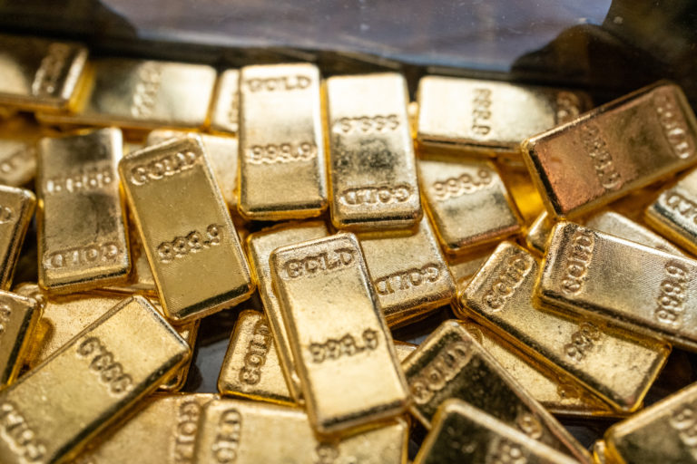gold bars on black background - MINING.COM